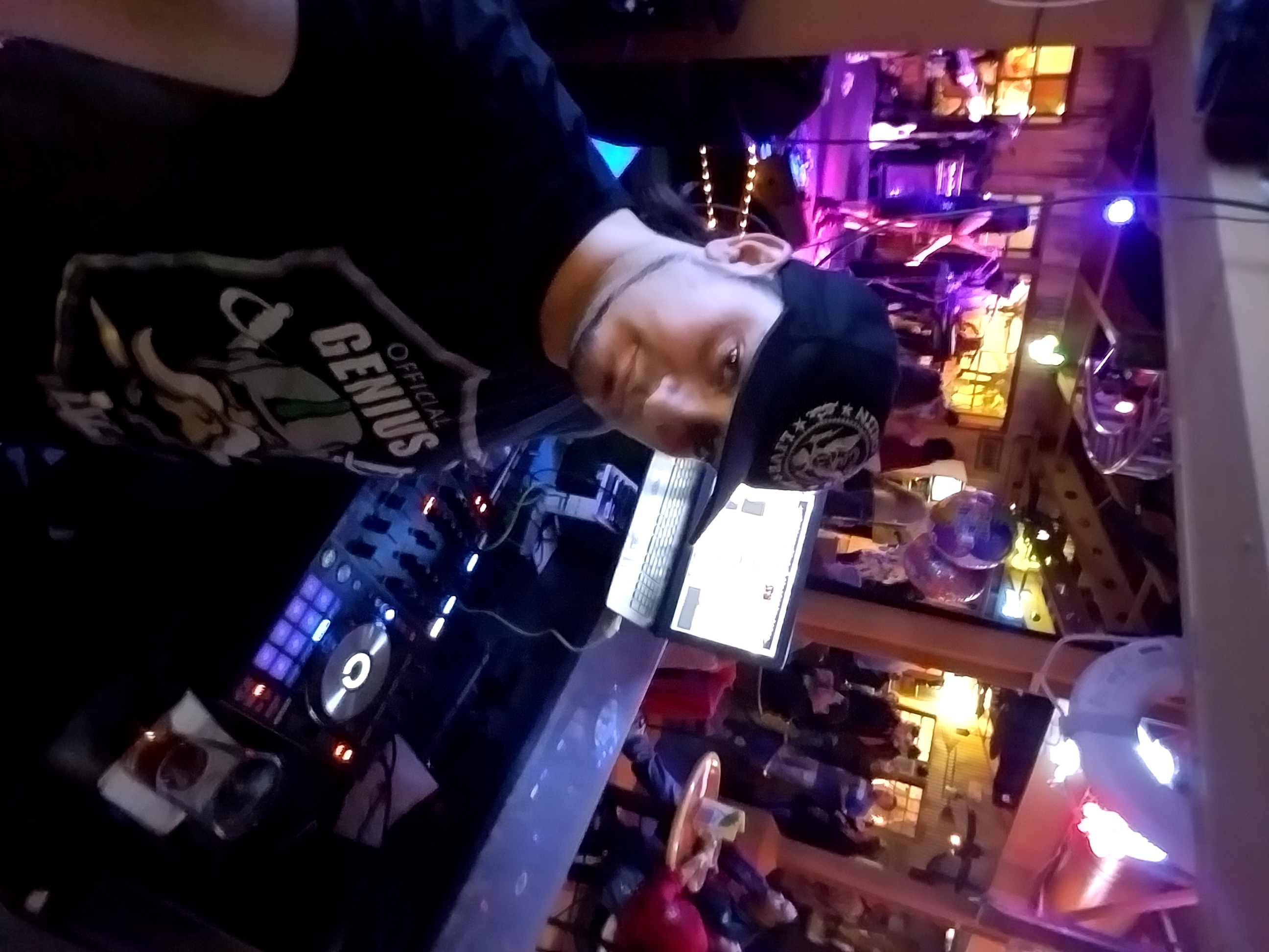 Kronik elevated above the DJ booth with controller and laptop overlooking the room
