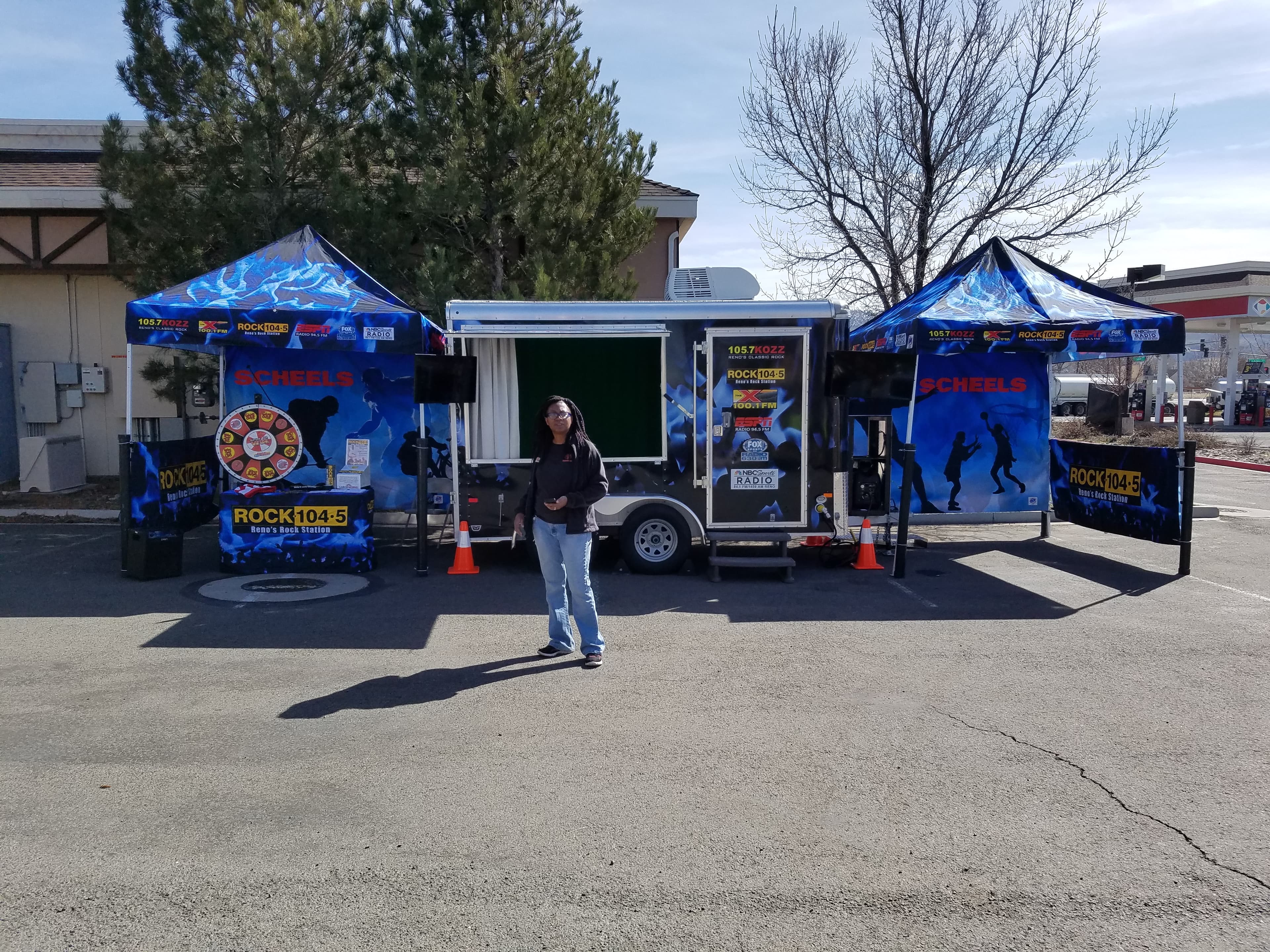 ROCK 104.5 KDOT and 105.7 KOZZ remote trailer with Scheels tents and prize wheel