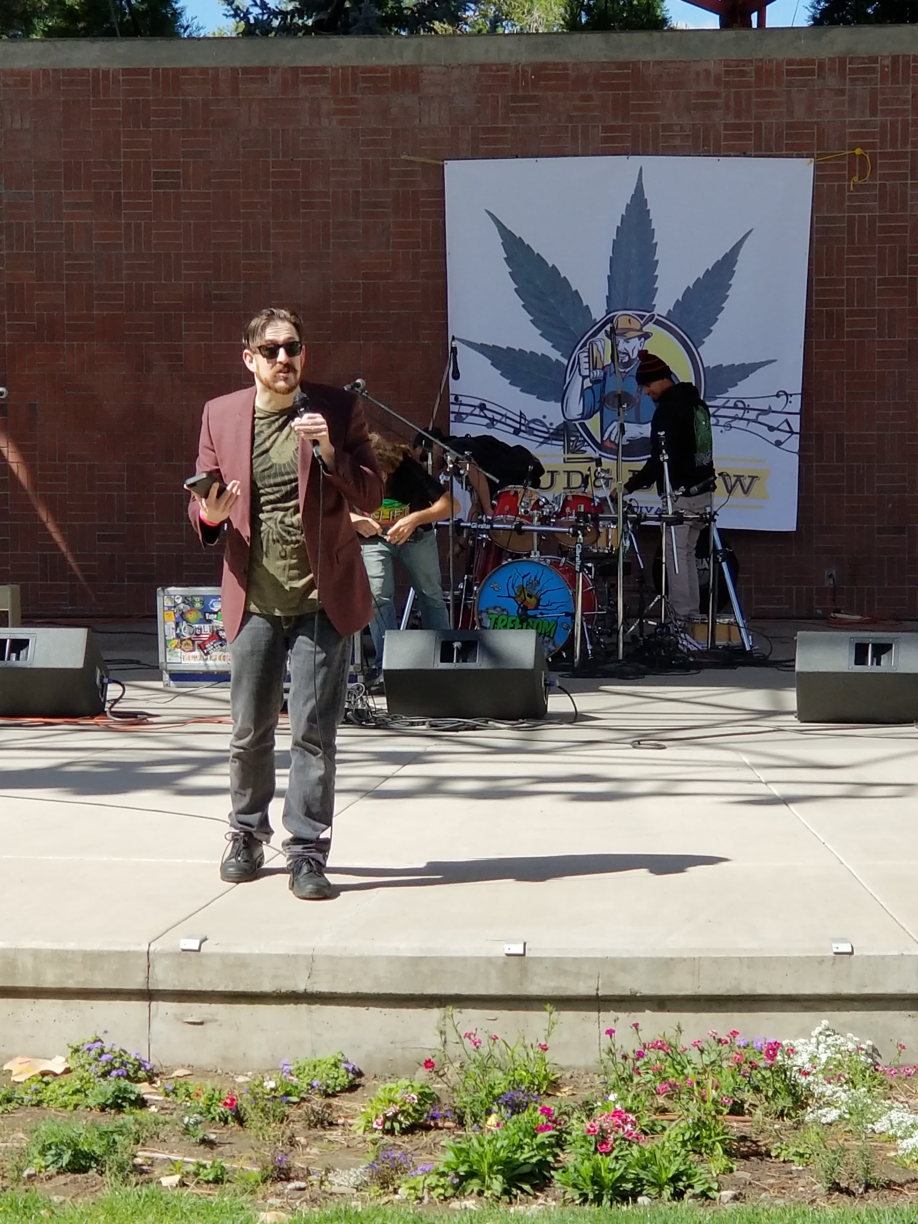 Performer on the Bud & Brew Music Festival outdoor stage with band behind