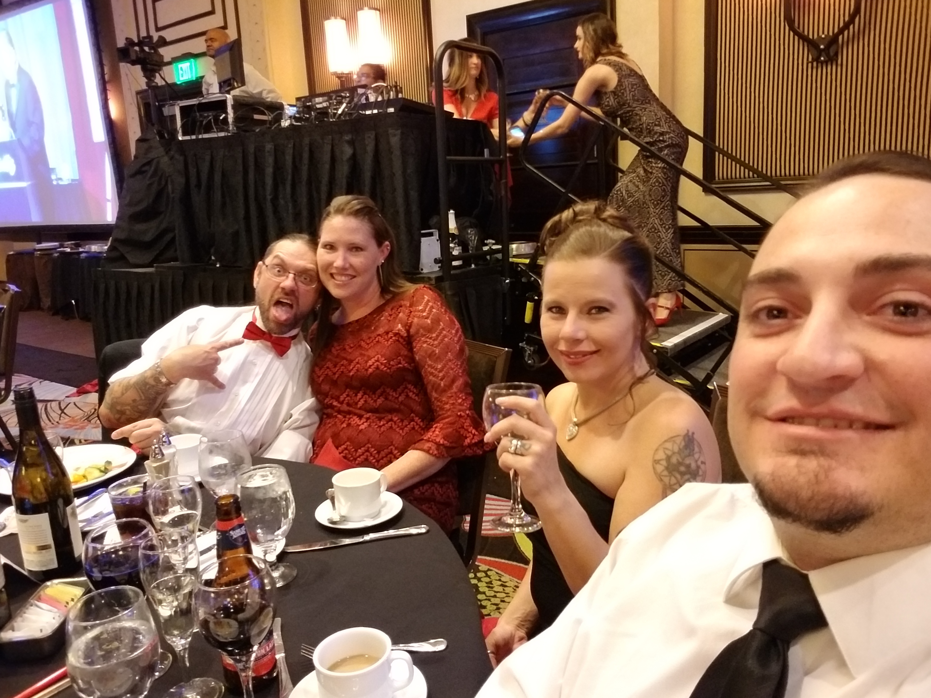 Kronik at the Red Shoe Gala for Ronald McDonald House with guests at a formal ballroom table