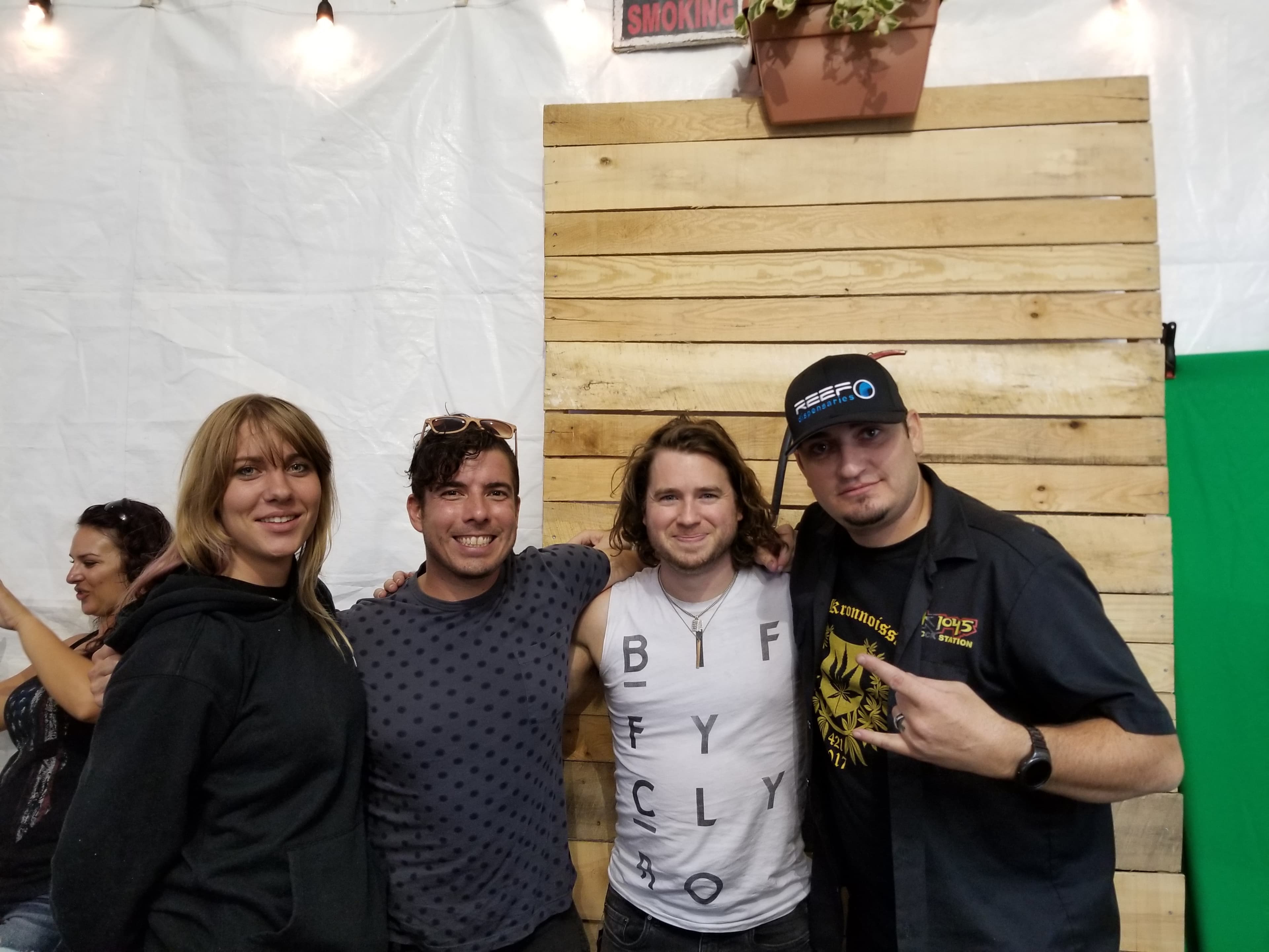 Kronik in ROCK 104.5 shirt with guests at Aftershock Festival green screen area