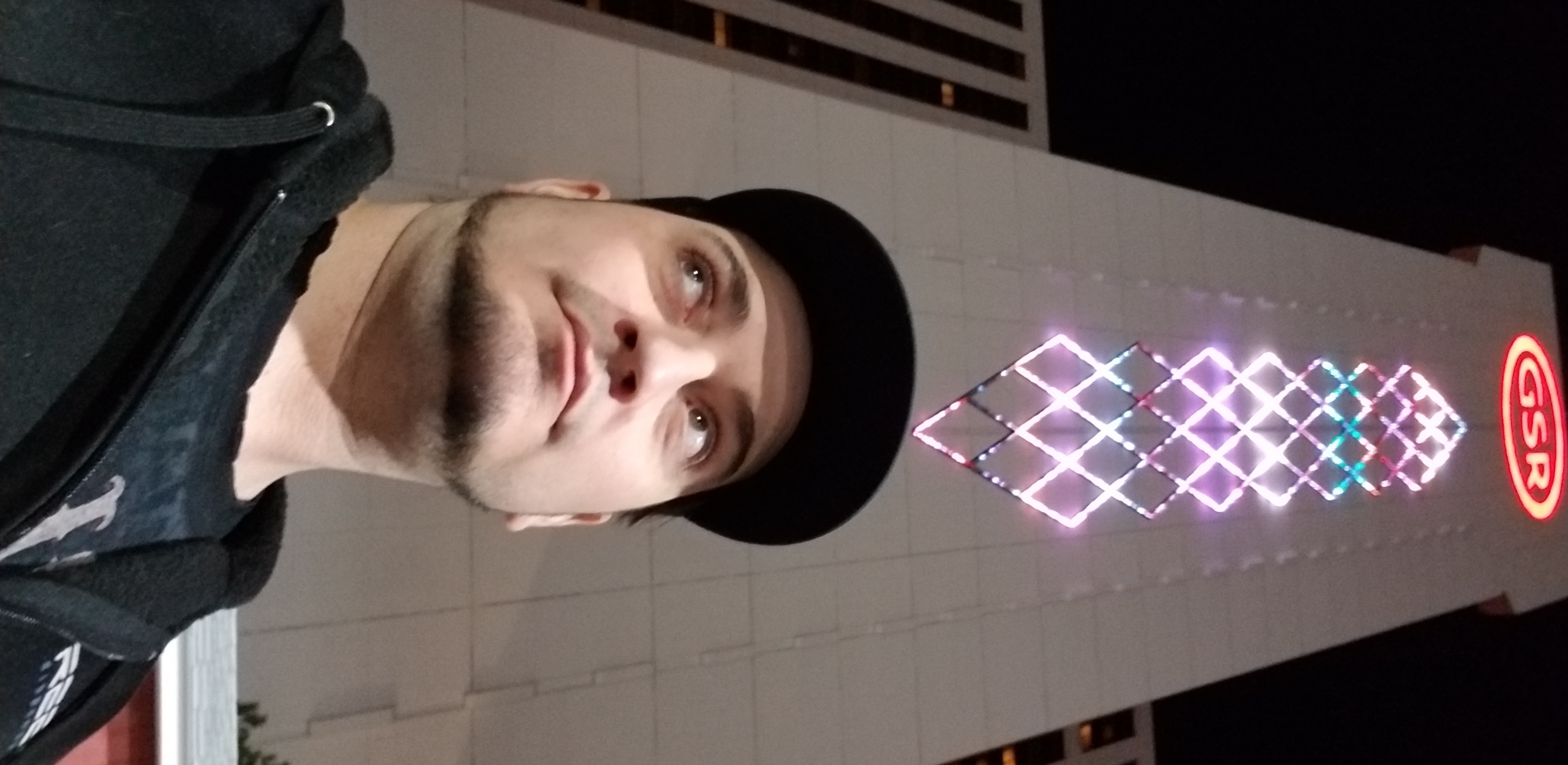 Kronik selfie at night under the Grand Sierra Resort GSR tower lights in Reno