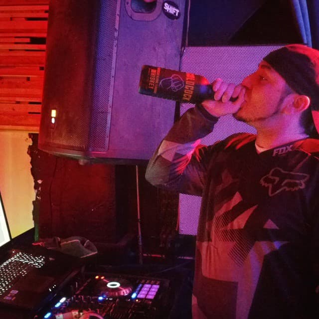 DJ Kronik preparing for a set at Tonic Lounge